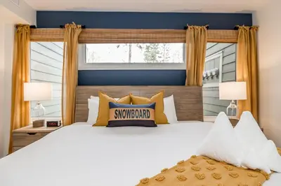 a bedroom with a large white bed with yellow pillows at Lift Side Luxury Newly renovated walk to village in Blue Mountains