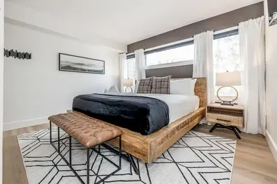 a bedroom with a large bed and a window at Lift Side Luxury Newly renovated walk to village in Blue Mountains