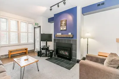 a living room with a couch and a fireplace at Chateau Ridge Retreat - Ski-In Ski-Out Winter Fun in Blue Mountains