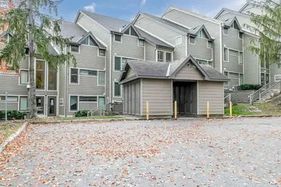 a large house with a driveway in front of it at Chateau Ridge Retreat - Ski-In Ski-Out Winter Fun in Blue Mountains