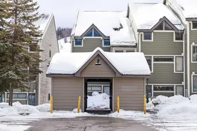 a house with snow on top of it at Chateau Ridge Retreat - Ski-In Ski-Out Winter Fun in Blue Mountains