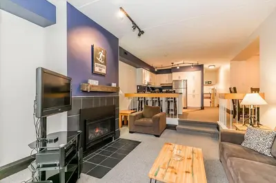 a living room with a tv and a fireplace at Chateau Ridge Retreat - Ski-In Ski-Out Winter Fun in Blue Mountains