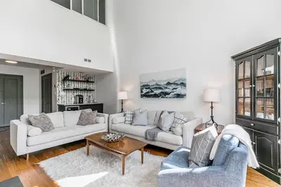 a living room with two couches and a table at First Tracks Ski-In Ski-Out & Walk to Village in Blue Mountains