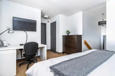 a bedroom with a bed and a desk and a computer at First Tracks Ski-In Ski-Out & Walk to Village in Blue Mountains