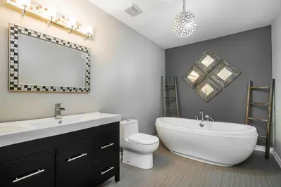 a bathroom with a tub and a sink and a toilet at Slopeside Haven - Ski-In Ski-Out Adventure Base in Blue Mountains