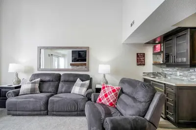 a living room with two chairs and a couch at Slopeside Haven - Ski-In Ski-Out Adventure Base in Blue Mountains