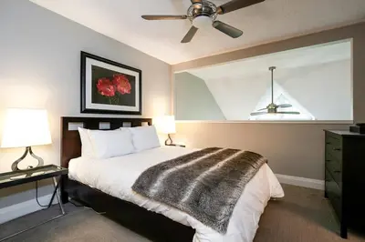 a bedroom with a bed and a ceiling fan at Hillside Lookout - Ski-In Ski-Out Alpine Escape in Blue Mountains