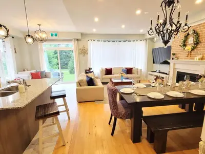 a kitchen and living room with a dining room table at Large 4 Br - 5 Bathroom with Heated Pool 2 King beds Sauna Pool Table in Blue Mountains