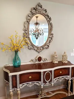 a dressing table with a mirror and a vase with flowers at Large 4 Br - 5 Bathroom with Heated Pool 2 King beds Sauna Pool Table in Blue Mountains