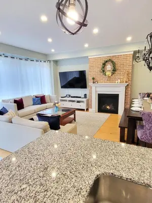 a living room with a couch and a fireplace at Large 4 Br - 5 Bathroom with Heated Pool 2 King beds Sauna Pool Table in Blue Mountains