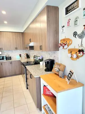 a kitchen with wooden cabinets and a counter top at Large 4 Br - 5 Bathroom with Heated Pool 2 King beds Sauna Pool Table in Blue Mountains