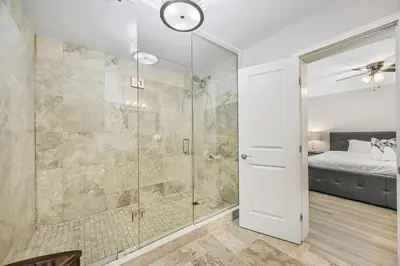 a bathroom with a shower with a glass door at Slopeside Hideout Ski-In Ski-Out Walk to Village in Blue Mountains