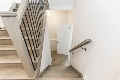 a hallway with a spiral staircase in a house at Modern Luxury Townhome Walk to Blue Shuttle in Blue Mountains