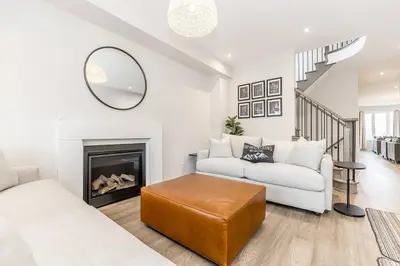a living room with a couch and a fireplace at Modern Luxury Townhome Walk to Blue Shuttle in Blue Mountains