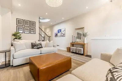 a living room with two couches and a table at Modern Luxury Townhome Walk to Blue Shuttle in Blue Mountains
