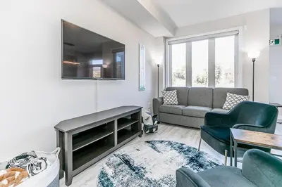 a living room with a couch and a tv at Family Townhouse Walk-Shuttle to Blue Fire Pit in Blue Mountains