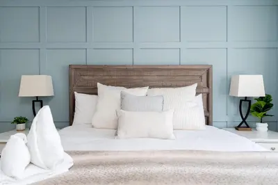 a white bed with white pillows and two lamps at Blue Mtn Village Retreat Walk to Blue - Shuttle in Collingwood