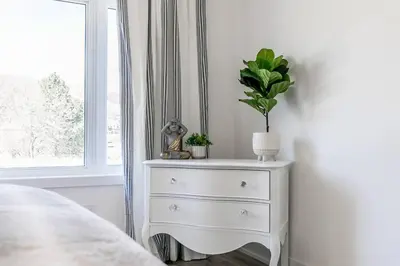 a bedroom with a white dresser with a plant on it at Blue Mtn Village Retreat Walk to Blue - Shuttle in Collingwood