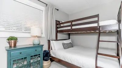 a bedroom with two bunk beds and a blue cabinet at Alpine Cove - Condo in Collingwood - Sleeps 6 in Collingwood