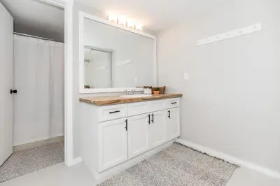 a white bathroom with a sink and a mirror at Alpine Cove - Condo in Collingwood - Sleeps 6 in Collingwood
