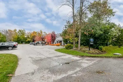 an empty street in a residential neighborhood with trees at Alpine Cove - Condo in Collingwood - Sleeps 6 in Collingwood