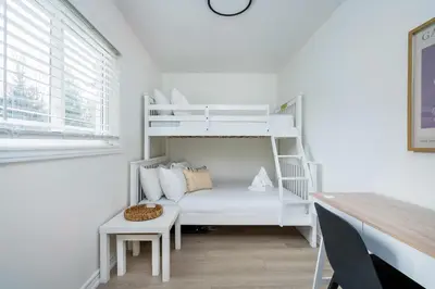 a white bunk bed in a white room with a desk at Cranberry Apres Nest Bright Reno Near Blue Mtn in Collingwood