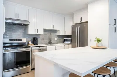 a kitchen with white cabinets and a white counter top at Cranberry Apres Nest Bright Reno Near Blue Mtn in Collingwood