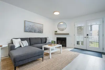 a living room with a couch and a table at Cranberry Apres Nest Bright Reno Near Blue Mtn in Collingwood