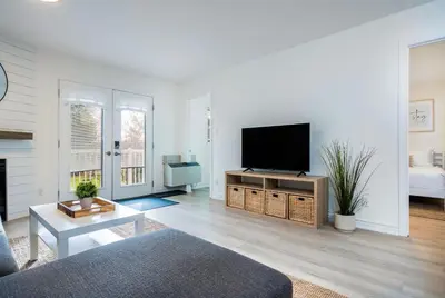 a living room with a flat screen tv at Cranberry Apres Nest Bright Reno Near Blue Mtn in Collingwood