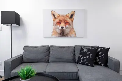 a fox head hanging on a wall above a couch at The Fox Den - Modern Condo Collingwood - Sleeps 5 in Collingwood