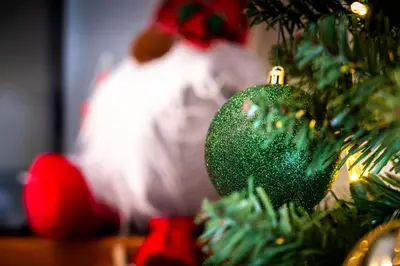 a green christmas ornament on a christmas tree at South Wind - Modern Condo in Collingwood - Sleep 5 in Collingwood