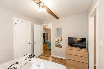 a bedroom with a bed and a flat screen tv at South Wind - Modern Condo in Collingwood - Sleep 5 in Collingwood