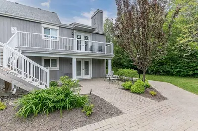 a house with a balcony and a patio at South Wind - Modern Condo in Collingwood - Sleep 5 in Collingwood