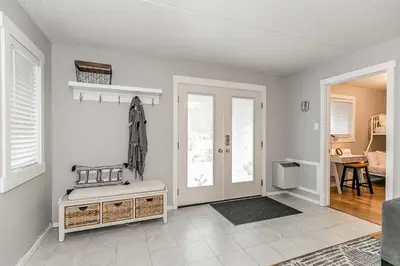 a living room with white walls and a door at South Wind - Modern Condo in Collingwood - Sleep 5 in Collingwood