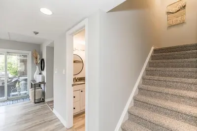 a staircase in a home with white walls at The Nest - Walk to Blue Private Patio in Blue Mountains