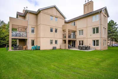 a large house with a lawn in front of it at The Nest - Walk to Blue Private Patio in Blue Mountains