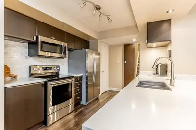 a kitchen with stainless steel appliances and a sink at Mountain Walk Retreat - Walk to Blue Patio area in Blue Mountains