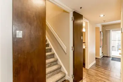 a staircase in a home with a wooden door at Mountain Walk Retreat - Walk to Blue Patio area in Blue Mountains