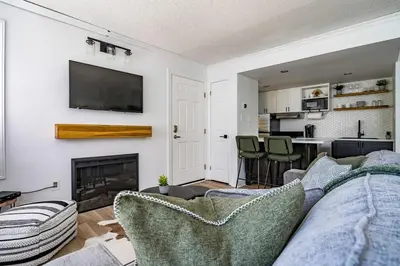 a living room with a couch and a fireplace at Sweet Retreat Ski-In Ski-Out - Pool & Hot Tub in Blue Mountains