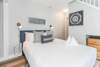 a bedroom with a large white bed with pillows at Wanderer Way Loft Ski-In Ski-Out - Pool & Hot Tub in Blue Mountains
