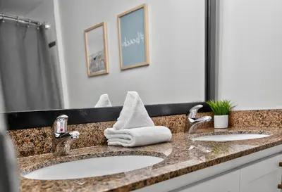 a bathroom with two sinks and a large mirror at Heavenly Hideaway Ski-In-Out Pool Shuttle in Blue Mountains
