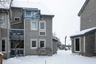 a house with snow on the ground in front of it at Heavenly Hideaway Ski-In-Out Pool Shuttle in Blue Mountains