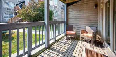 a porch with two chairs on a house at Heavenly Hideaway Ski-In-Out Pool Shuttle in Blue Mountains
