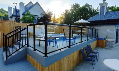 a deck with a table and chairs on it at Mountain Peaks Ski-In-Out Pool Shuttle in Blue Mountains