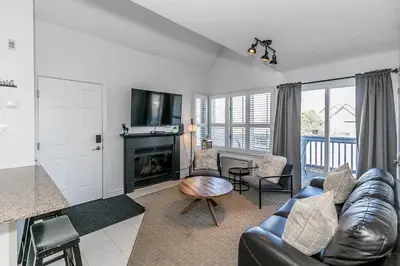 a living room with a couch and a fireplace at Mountain Peaks Ski-In-Out Pool Shuttle in Blue Mountains