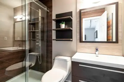 a bathroom with a toilet and a sink and a mirror at Foxwood Retreat - Shuttle to Blue Pool & Hot Tub in Blue Mountains