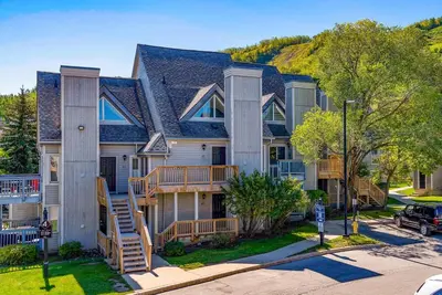 a large house with a staircase in front of it at Foxwood Retreat - Shuttle to Blue Pool & Hot Tub in Blue Mountains
