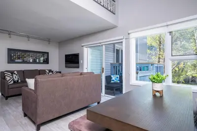 a living room with a couch and a table at Foxwood Retreat - Shuttle to Blue Pool & Hot Tub in Blue Mountains