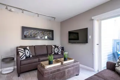 a living room with a couch and a tv at Foxwood Retreat - Shuttle to Blue Pool & Hot Tub in Blue Mountains