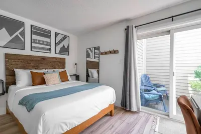 a bedroom with a large bed and a large window at Arrowhead Retreat Ski-In-Out Pool Shuttle in Blue Mountains
